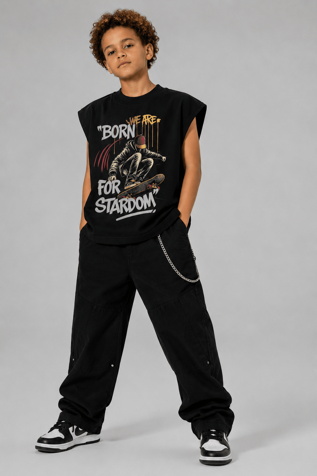 MILANI Born for Stardom Heavyweight Sleeveless Tee – Black - MILANI CLOTHINGMILANI Born for Stardom Heavyweight Sleeveless Tee – BlackMILANI CLOTHINGMILANI CLOTHING6-7 yearsYoung person wearing a black sleeveless shirt with graphic design and text, standing against a plain background.