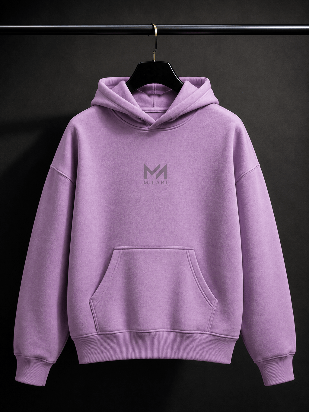 MILANI Freedom Kids Heavyweight Hoodie – Lavender - MILANI CLOTHINGMILANI Freedom Kids Heavyweight Hoodie – LavenderMILANI CLOTHING PTY LIMITEDMILANI CLOTHING4-6 YearsA lavender purple pullover hoodie with a gray 'MILANI' logo printed on the chest, hanging on a black hanger from a black clothing rack against a dark gray background.