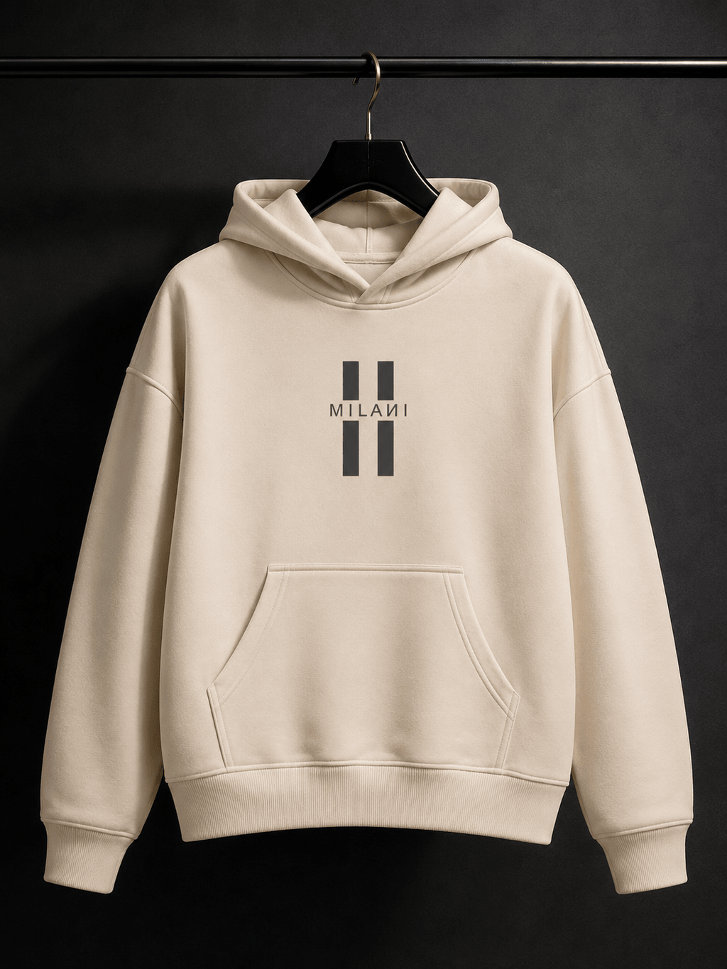 MILANI Untamed Heavyweight Kids Hoodie – Cream - MILANI CLOTHINGMILANI Untamed Heavyweight Kids Hoodie – CreamLoosefit Heavyweight hoodieMILANI CLOTHINGMILANI CLOTHING4-6 YearsA cream-colored pullover hoodie with a black double-stripe logo and the word 'MILANI' printed on the chest, hanging on a black hanger against a dark background.